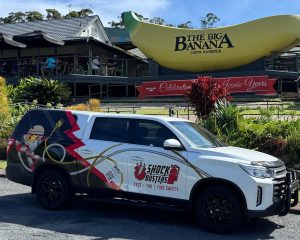 Shock Busters Test and Tag vehicle parked near the Big Banana monument in Coffs Harbour, New South Wales.