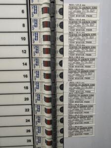 Commercial electrical switchboard with printed RCD trip-time test tags showing millisecond safety pass results